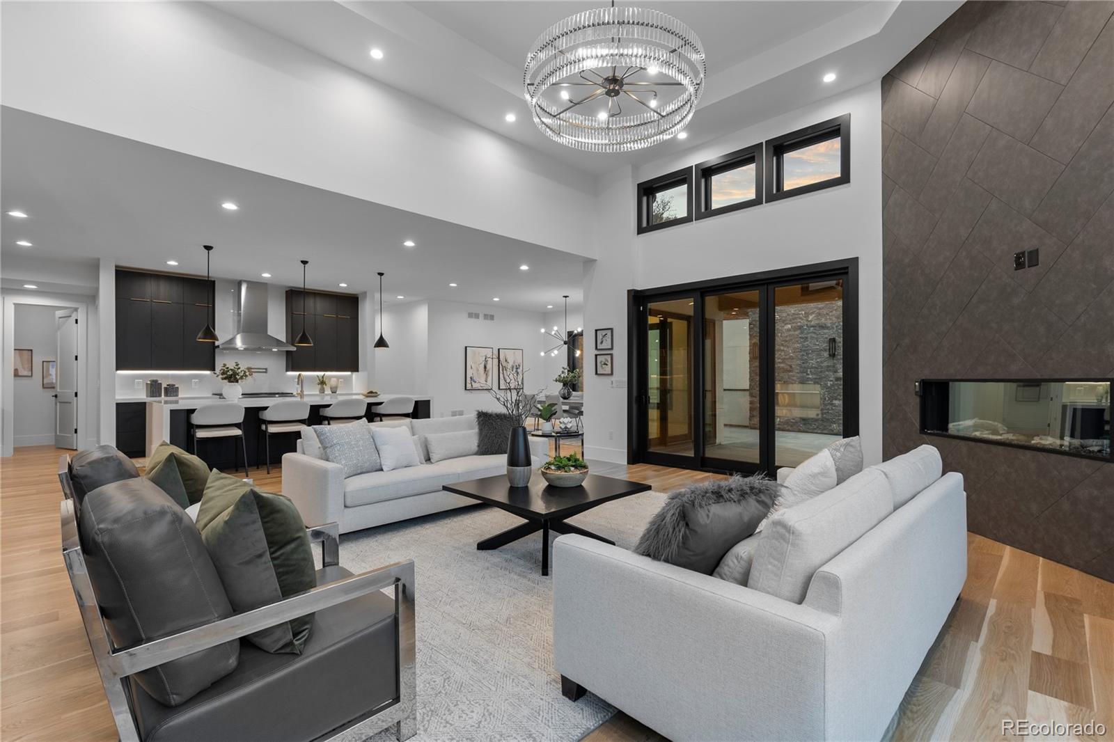 8103 Raphael Lane Littleton, CO 80125 - Photo 12 of 31 a living room with furniture kitchen view and a chandelier