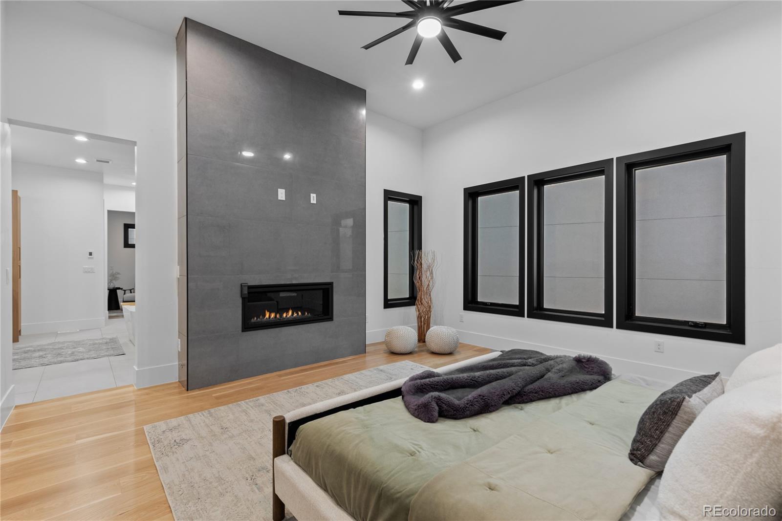 8103 Raphael Lane Littleton, CO 80125 - Photo 17 of 31 a bedroom with a bed and a fireplace