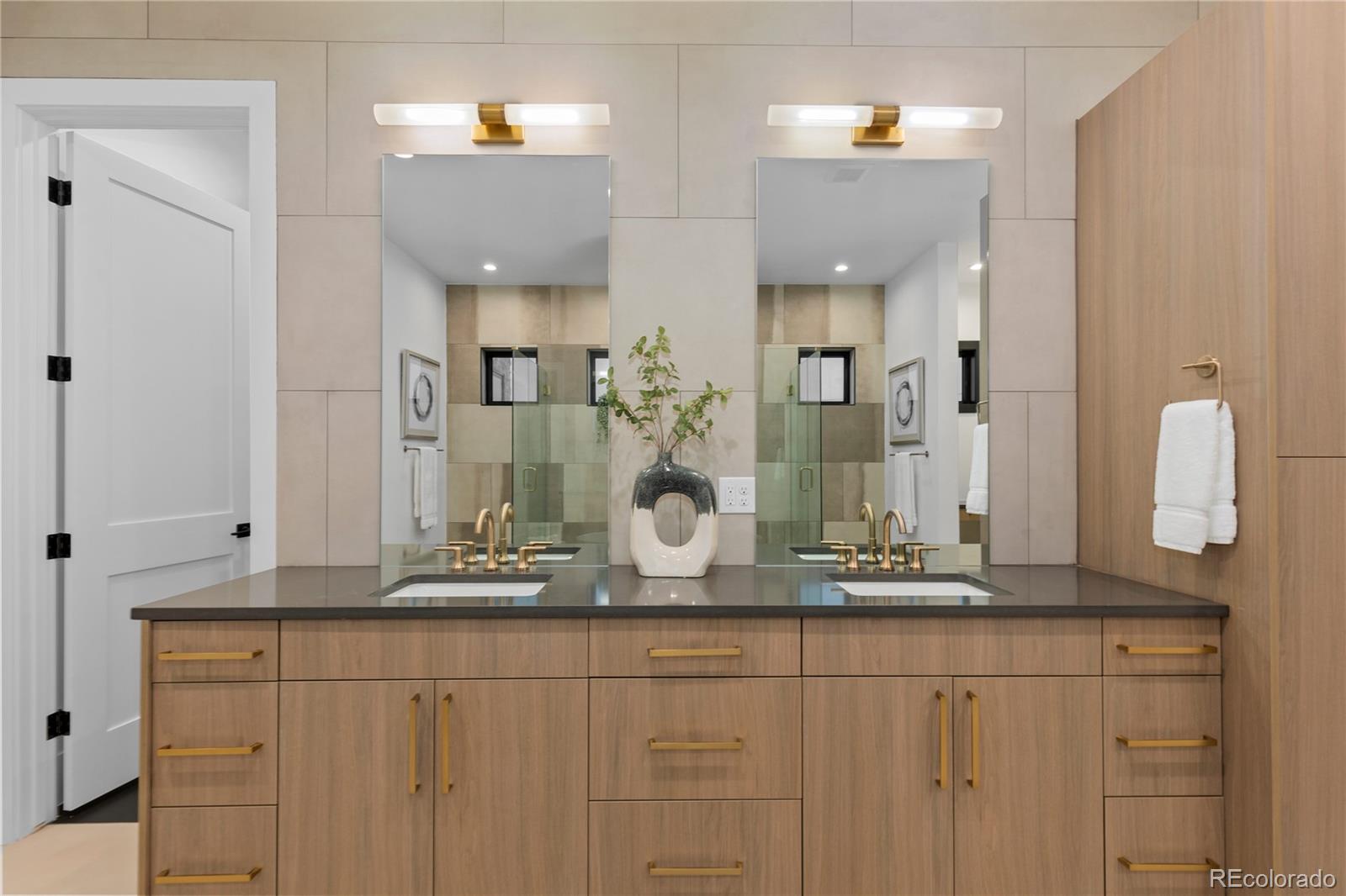 8103 Raphael Lane Littleton, CO 80125 - Photo 20 of 31 a bathroom with a granite countertop sink and a mirror