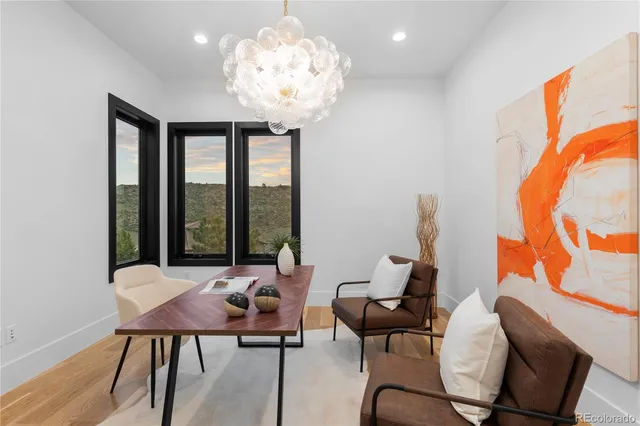 a view of a livingroom with wooden floor and a ceiling fan
