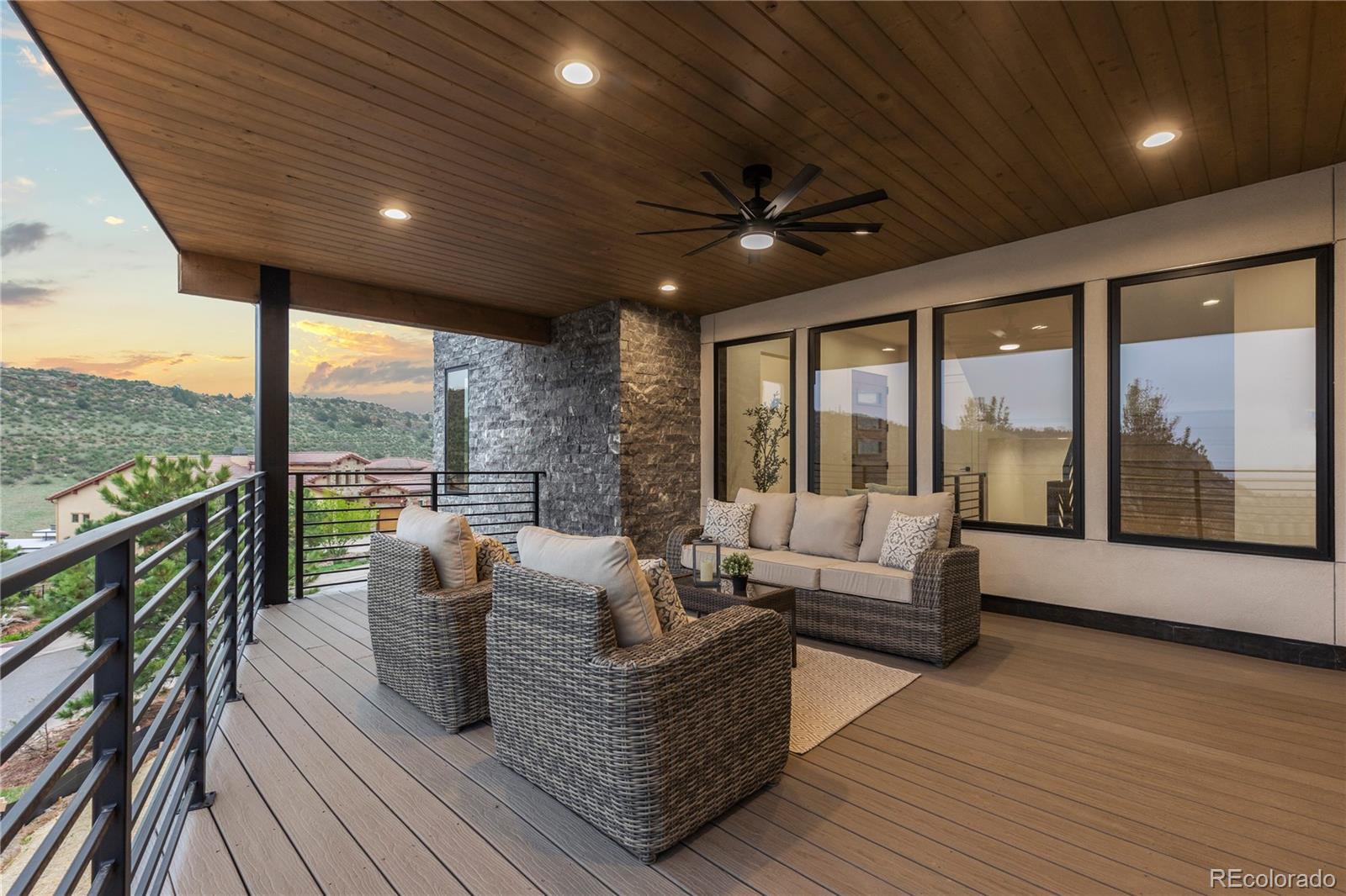 8103 Raphael Lane Littleton, CO 80125 - Photo 4 of 31 a living room with furniture large windows and wooden floor
