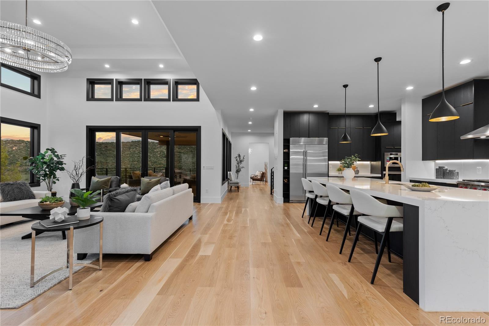 8103 Raphael Lane Littleton, CO 80125 - Photo 8 of 31 a living room with stainless steel appliances kitchen island a table and a sink