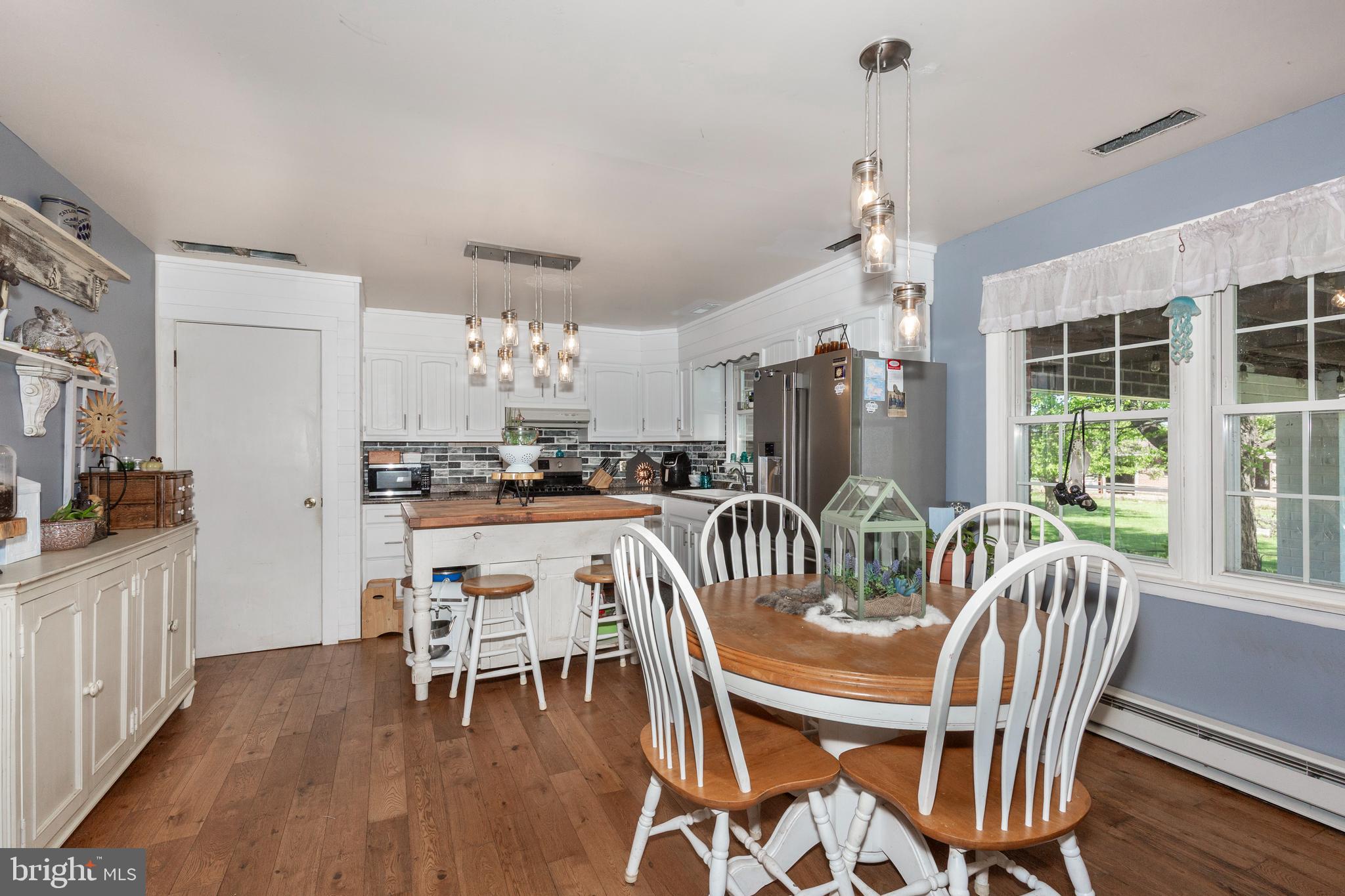 2226 Harney Road Littlestown, PA 17340 - Photo 32 of 113 a dining room with furniture a chandelier and wooden floor