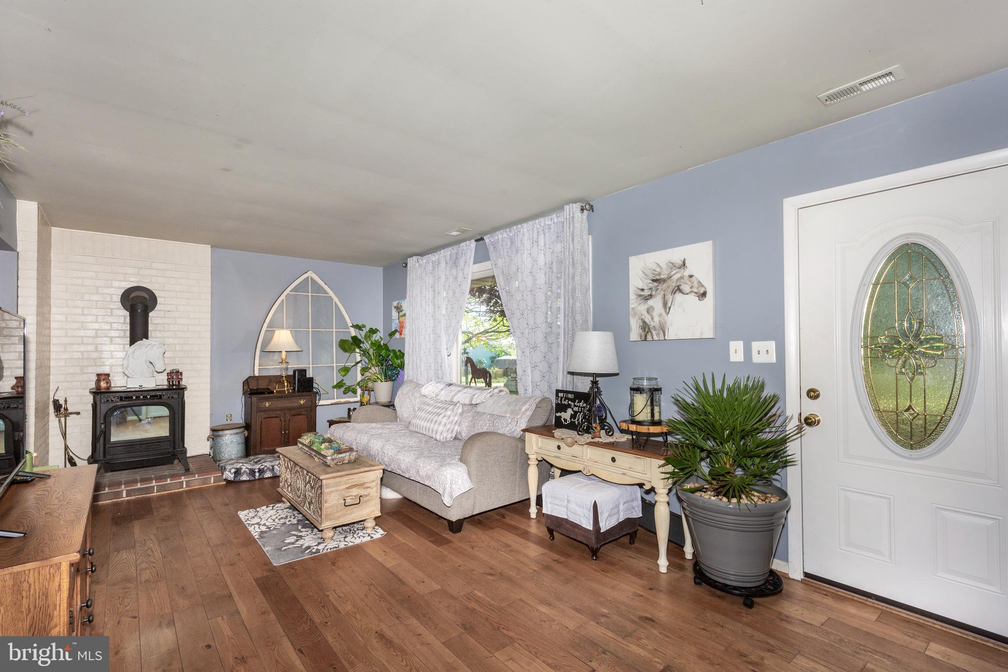 2226 Harney Road Littlestown, PA 17340 - Photo 39 of 113 a living room with furniture a potted plant and a fireplace