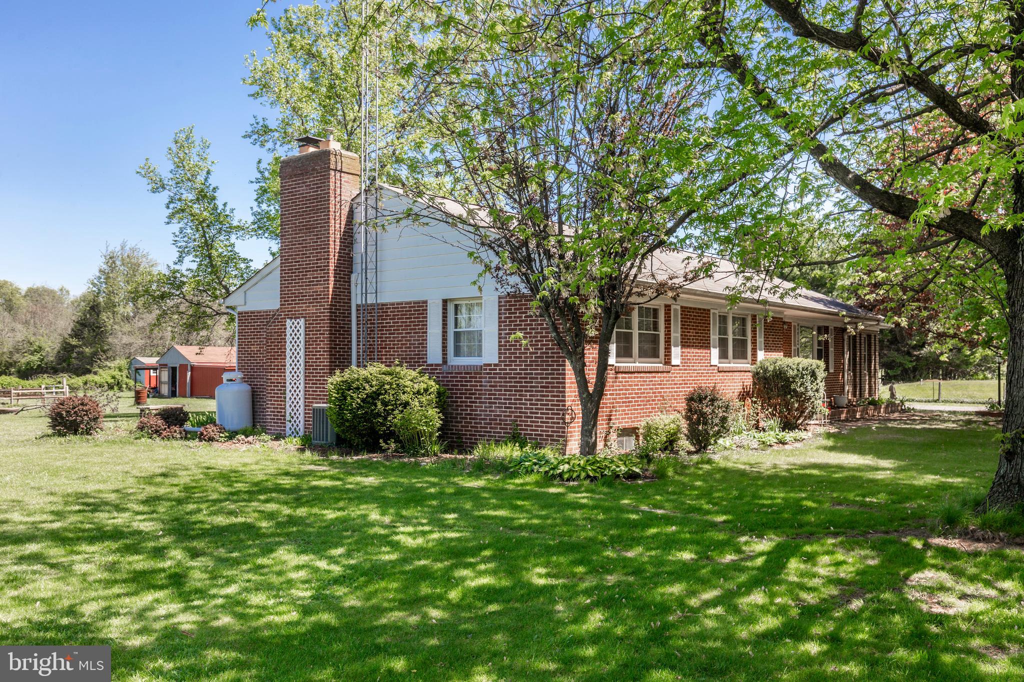 2226 Harney Road Littlestown, PA 17340 - Photo 68 of 113 a front view of a house with a garden and trees