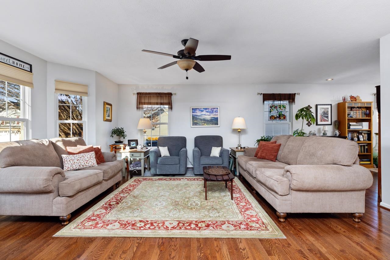 a living room with furniture wooden floor and window