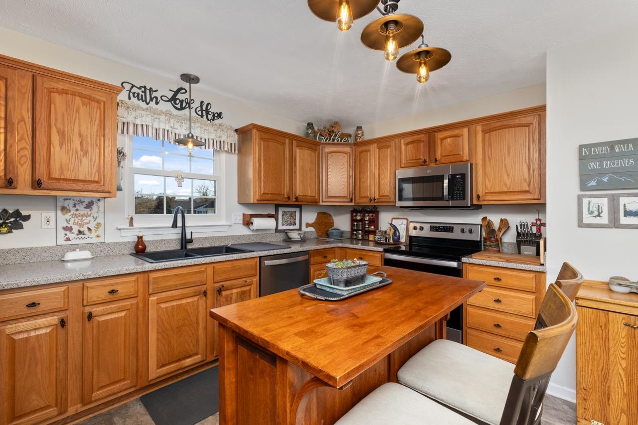 208 Kingsport Road Waynesboro, VA 22980 - Photo 15 of 38 a kitchen with a sink stove and microwave