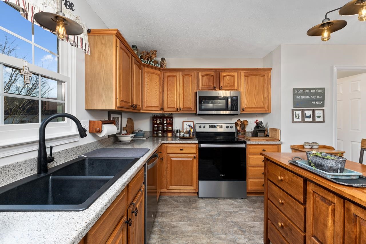 208 Kingsport Road Waynesboro, VA 22980 - Photo 16 of 38 a kitchen with stainless steel appliances granite countertop a stove a sink and a microwave