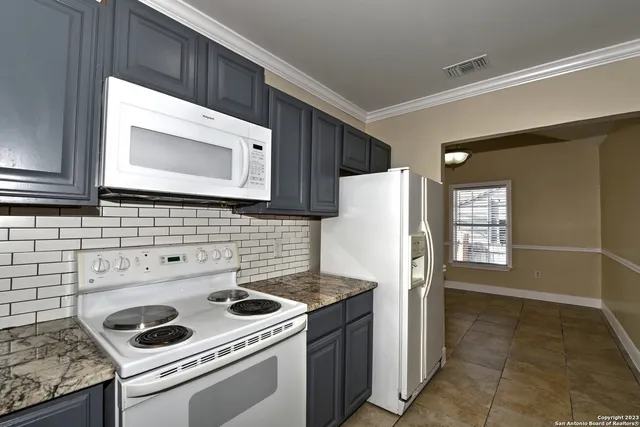 a kitchen with a stove microwave and refrigerator