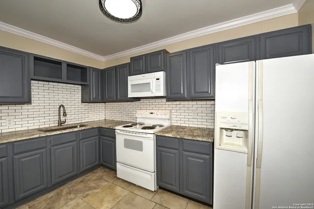 a kitchen with a sink dishwasher stove and refrigerator