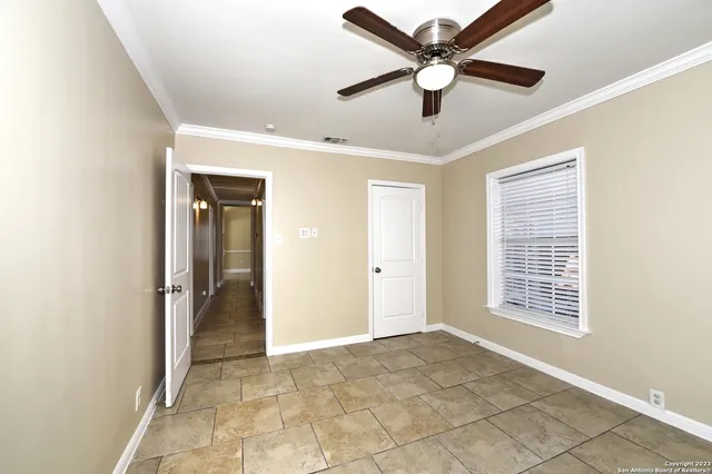 a view of an empty room with a ceiling fan