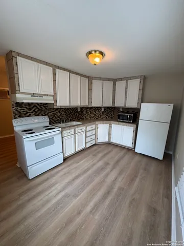 a kitchen with stainless steel appliances a stove a sink and a refrigerator