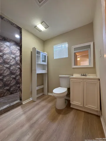 a spacious bathroom with a toilet sink and shower