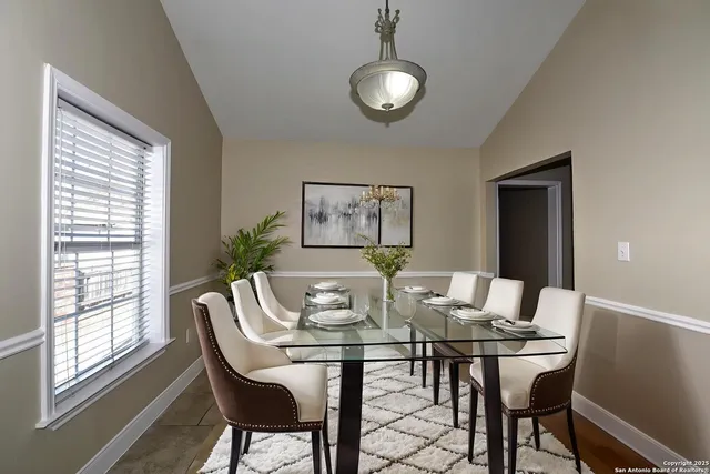 a view of a dining room with furniture and window