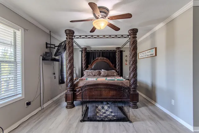 a bedroom with furniture and wooden floor