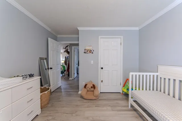 a bedroom with furniture and a wooden floor