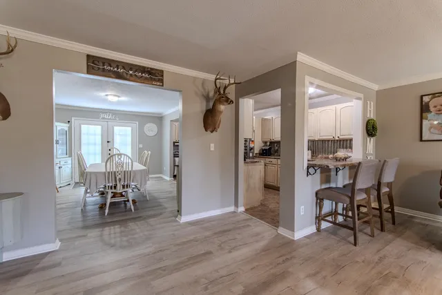 a view of a room with wooden floor and furniture