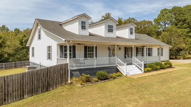 a front view of a house with a yard outdoor seating and barbeque oven