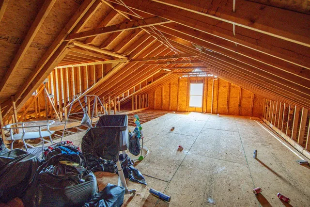 a view of a big house with wooden fence