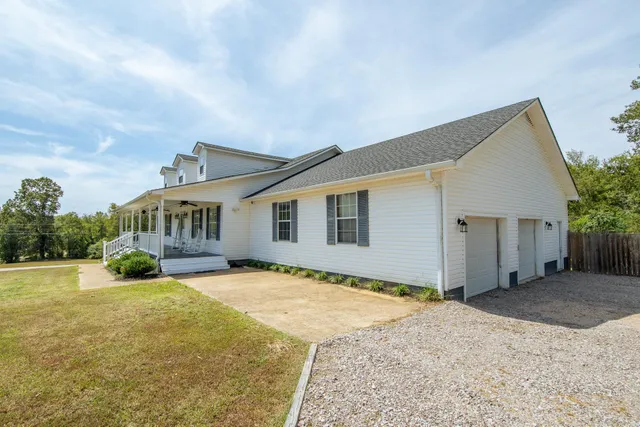 a front view of house with yard outdoor seating and barbeque oven