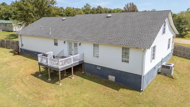 a aerial view of a house with pool table and chairs