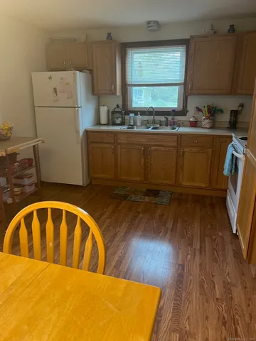 a kitchen with a wooden floor and cabinets