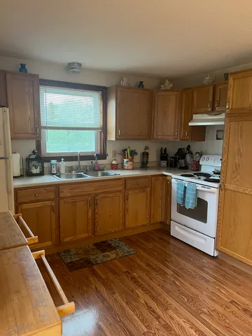 a kitchen with a sink a stove and cabinets