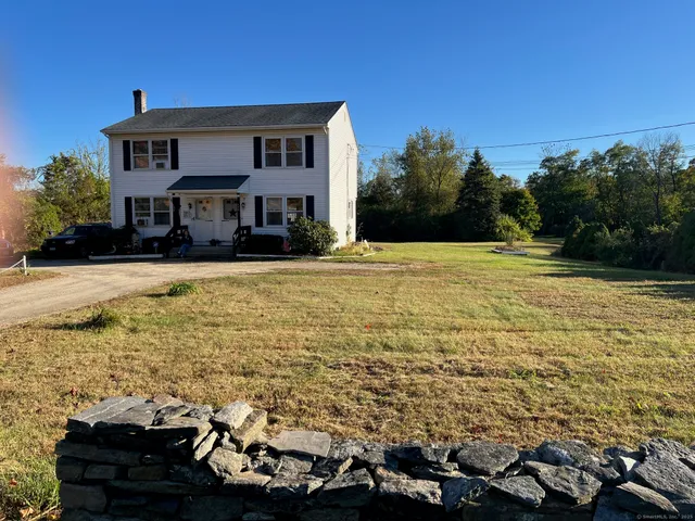 a house view with swimming pool and trees in the background
