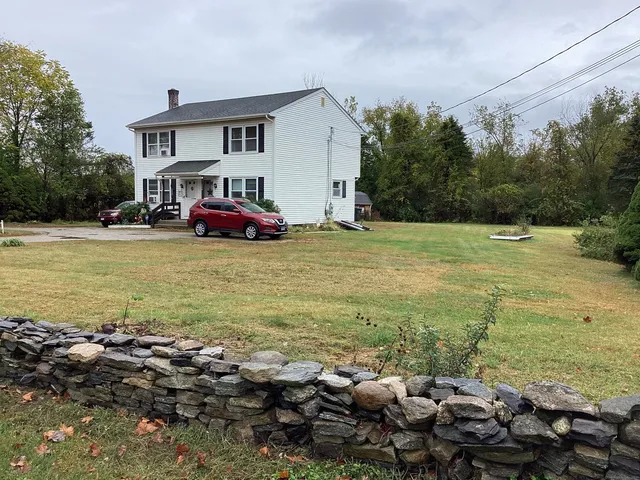 a view of a house with a yard and swimming pool