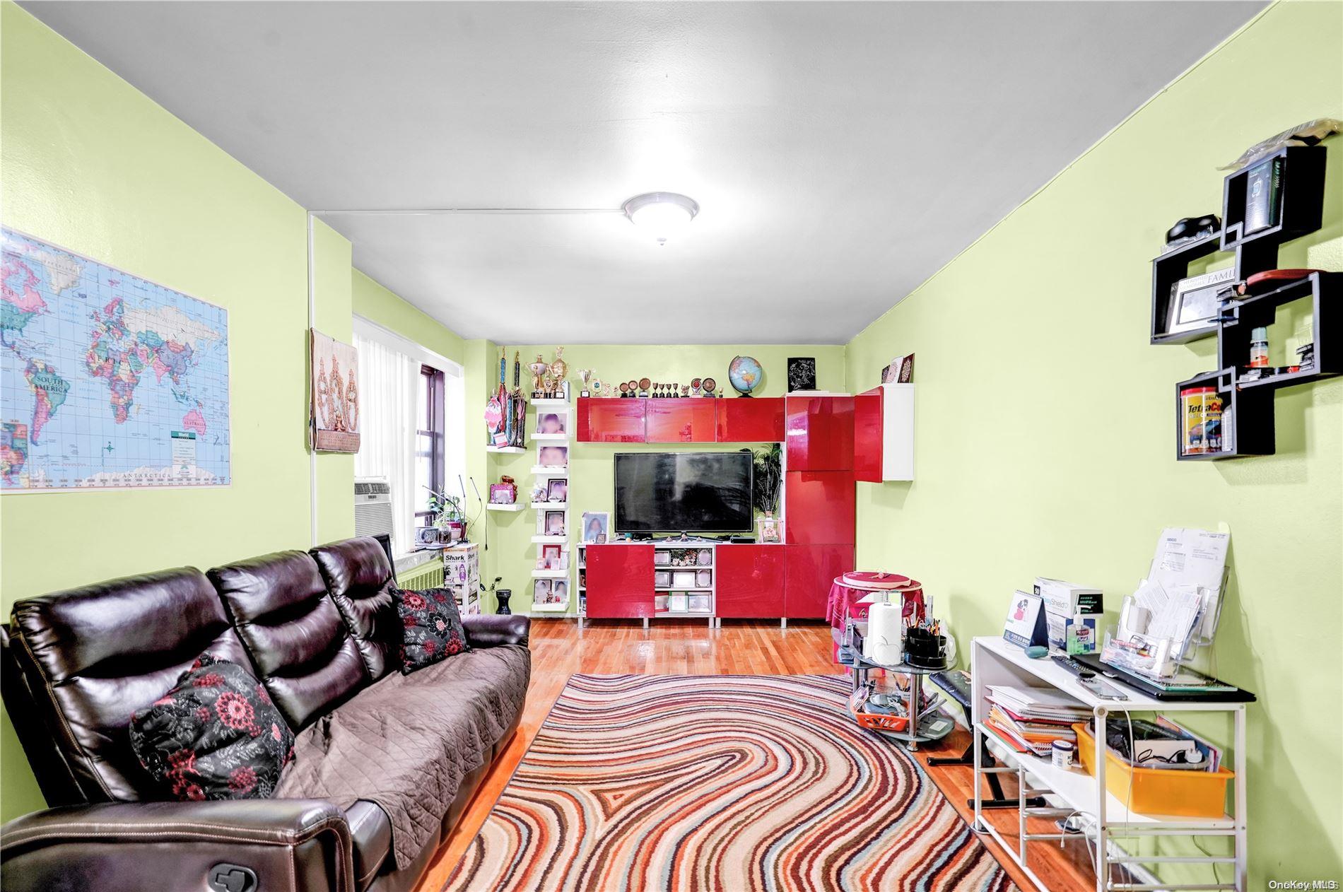 a living room with furniture workspace and a flat screen tv