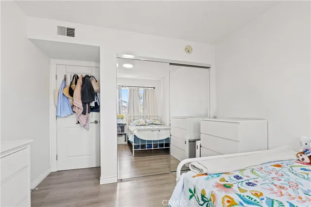 a white toilet sitting next to a white wall