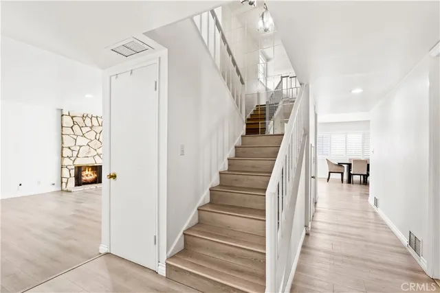 a view of a room with lots of frames on wall and stairs