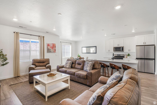 1705 Ripple Rock Drive, Unit 3017 Washington, UT 84780 - Photo 6 of 22 Open-concept living space featuring wood-finish flooring, recessed lighting, and white walls