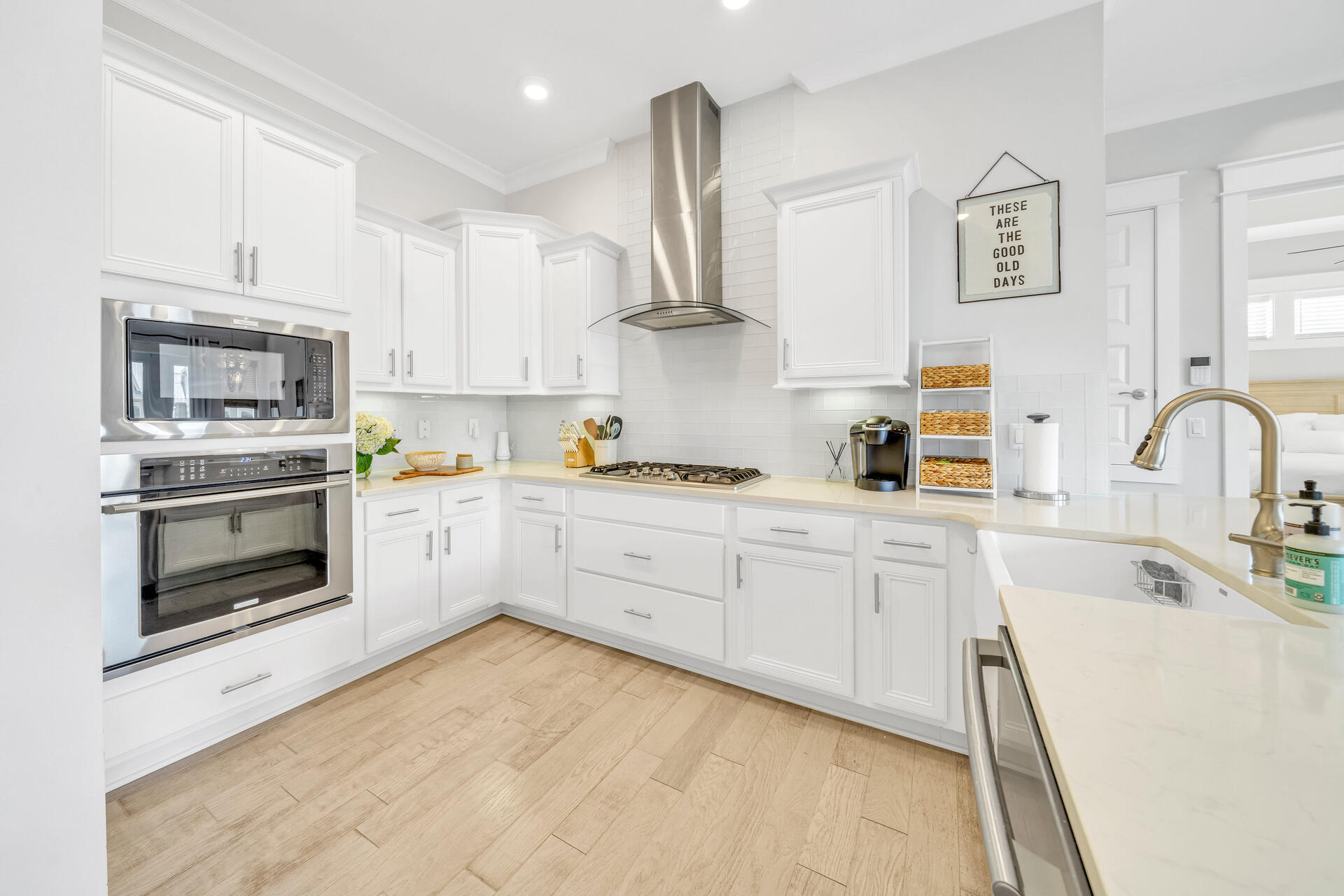 309 Milestone Dr Inlet Beach, Unit C Inlet Beach, FL 32461 - Photo 7 of 30 a kitchen with stainless steel appliances granite countertop a sink and cabinets with wooden floor
