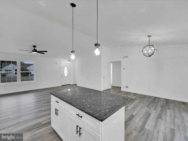 a kitchen with kitchen island a counter space a sink and appliances
