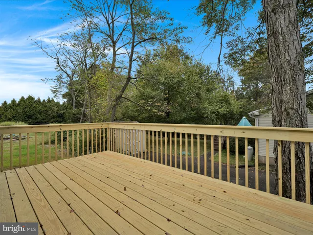 a balcony with wooden floor and fence