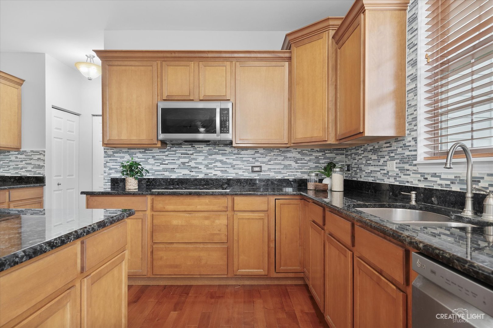 147 Gillett Street Sugar Grove, IL 60554 - Photo 15 of 32 a kitchen with stainless steel appliances granite countertop a sink a stove and cabinets