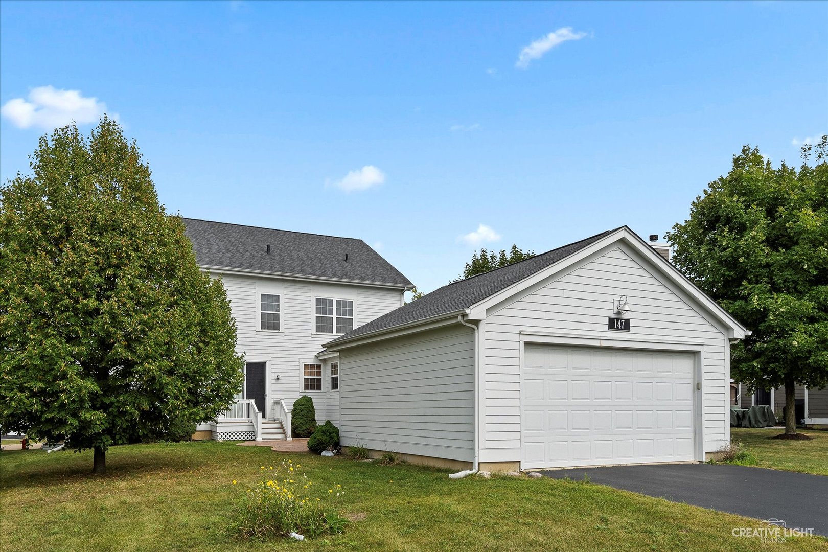 147 Gillett Street Sugar Grove, IL 60554 - Photo 26 of 32 a small white house with a white roof and a yard