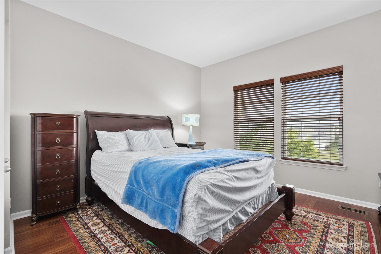 147 Gillett Street Sugar Grove, IL 60554 - Photo 9 of 32 a bedroom with a bed and a dresser next to a window