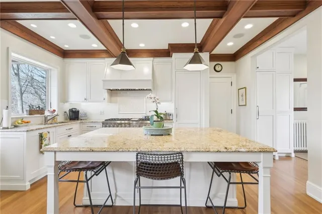 a kitchen with a table chairs and white cabinets