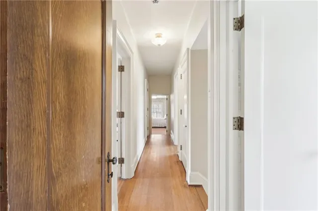 a bedroom with a bed mirror and window