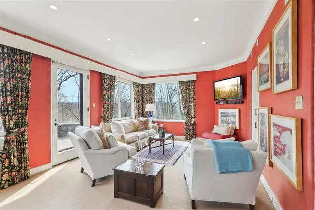 a living room with furniture and large windows