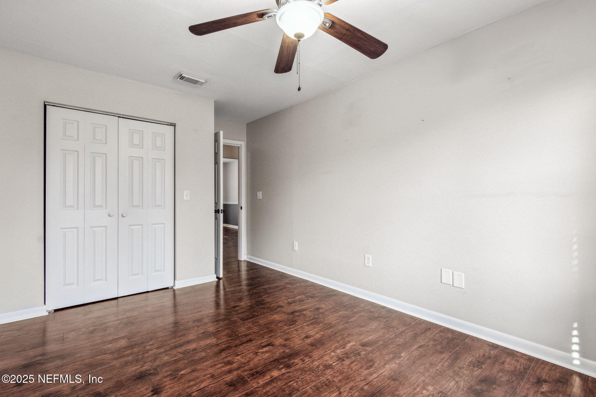86221 Spring Meadow Avenue Yulee, FL 32097 - Photo 12 of 23 an empty room with wooden floor closet and ceiling fan