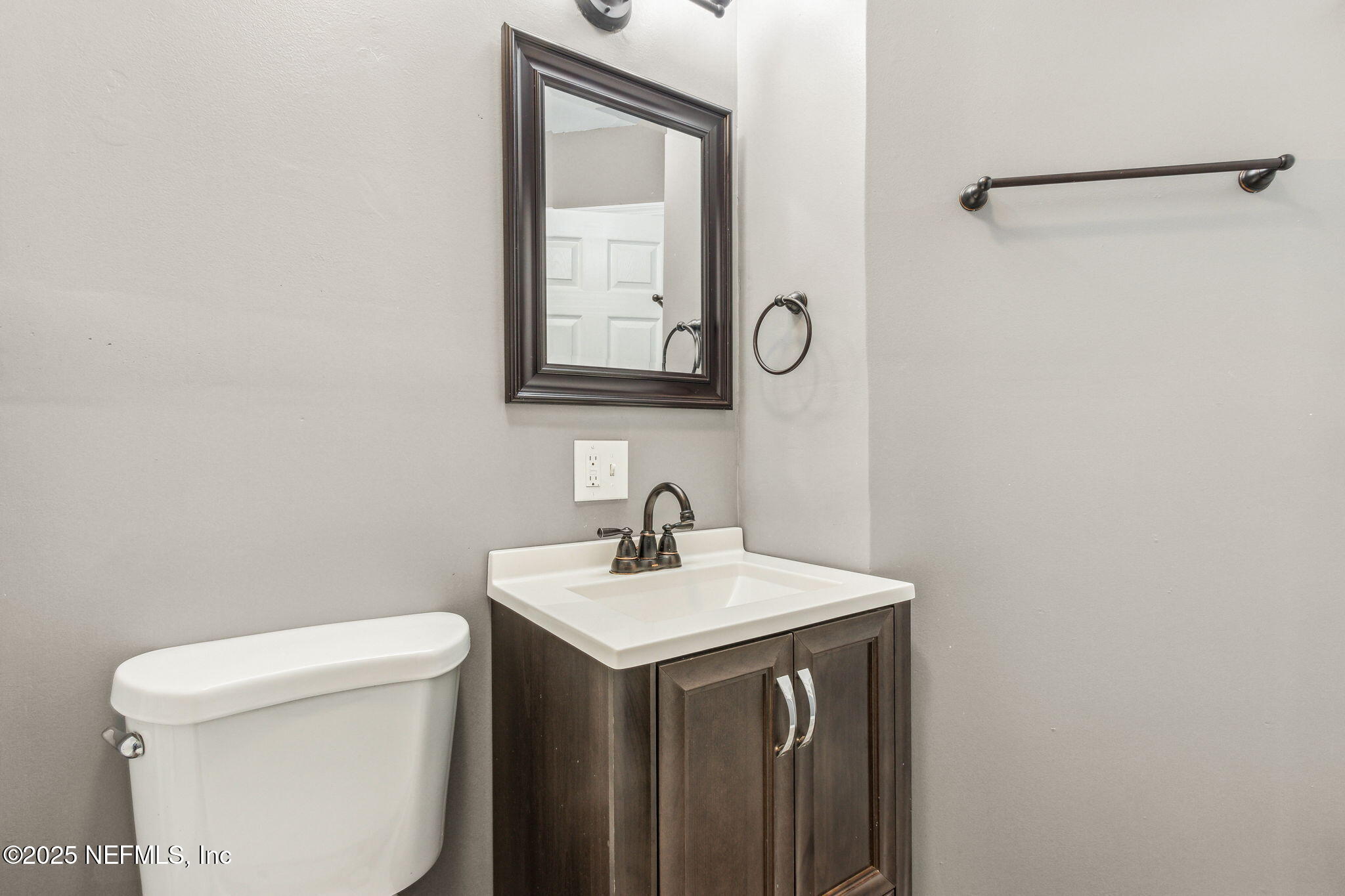 86221 Spring Meadow Avenue Yulee, FL 32097 - Photo 14 of 23 a bathroom with a sink a toilet and a mirror