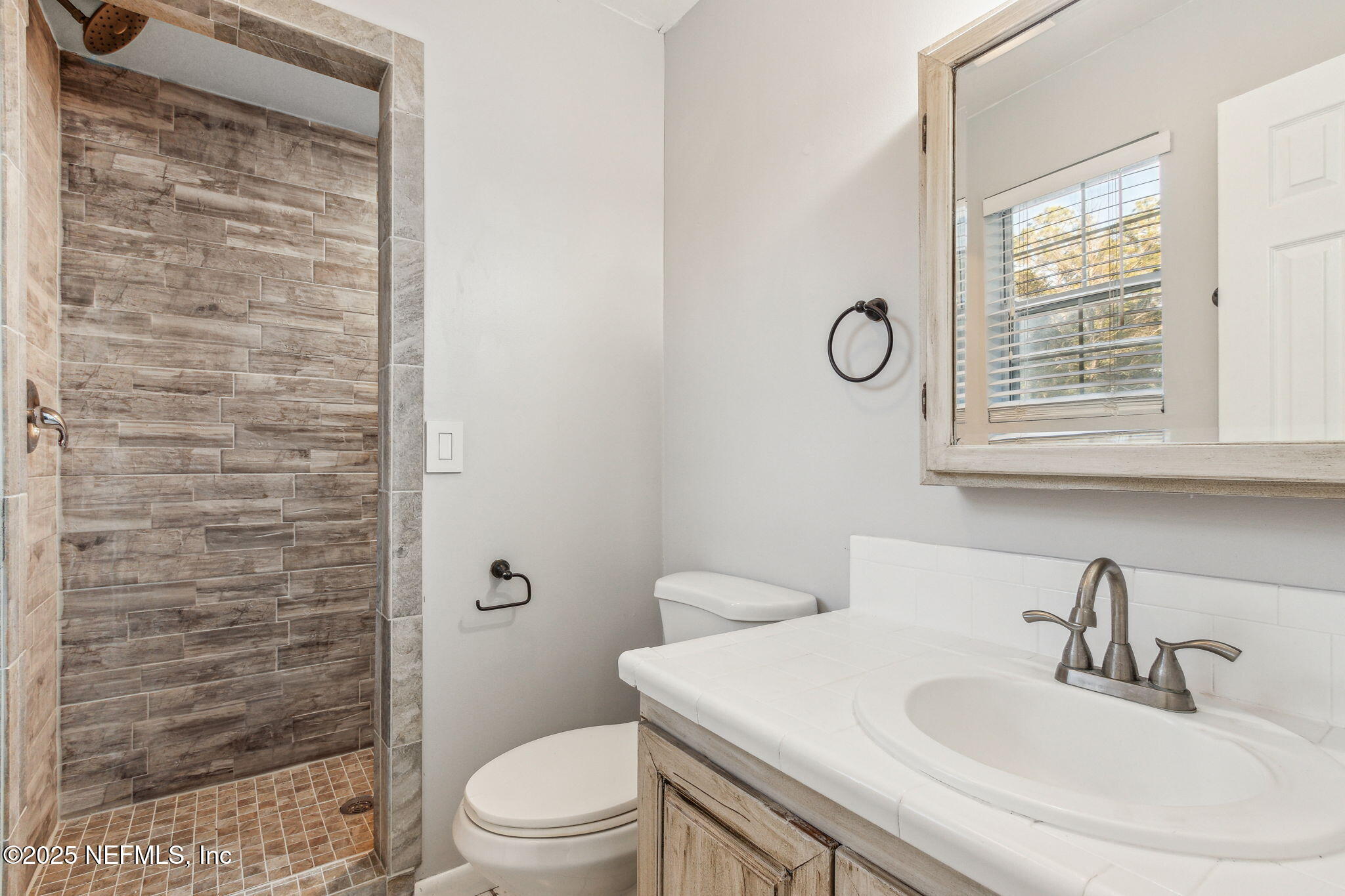 86221 Spring Meadow Avenue Yulee, FL 32097 - Photo 17 of 23 a bathroom with a sink a toilet and shower