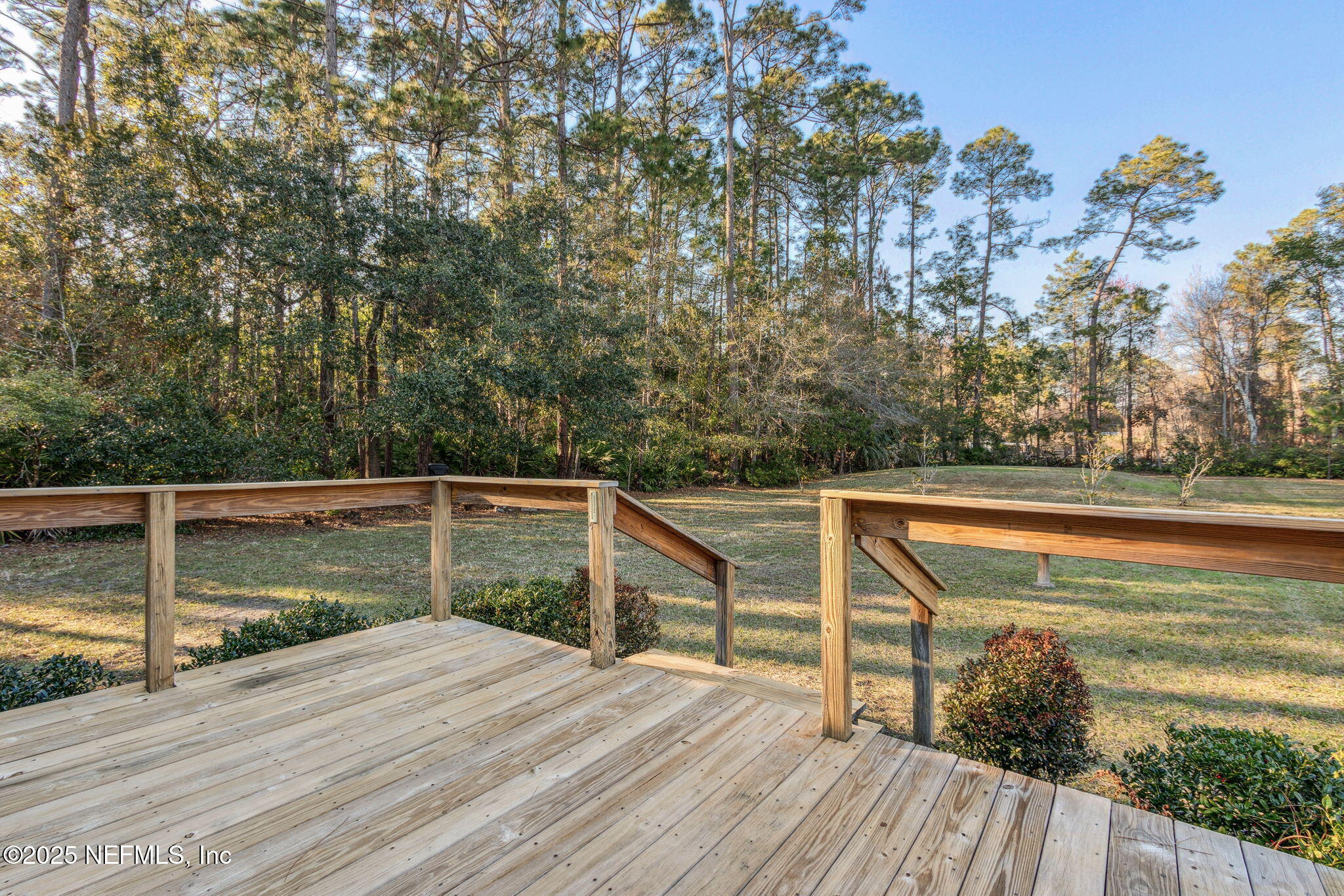 86221 Spring Meadow Avenue Yulee, FL 32097 - Photo 19 of 23 a view of a roof deck with wooden floor and fence