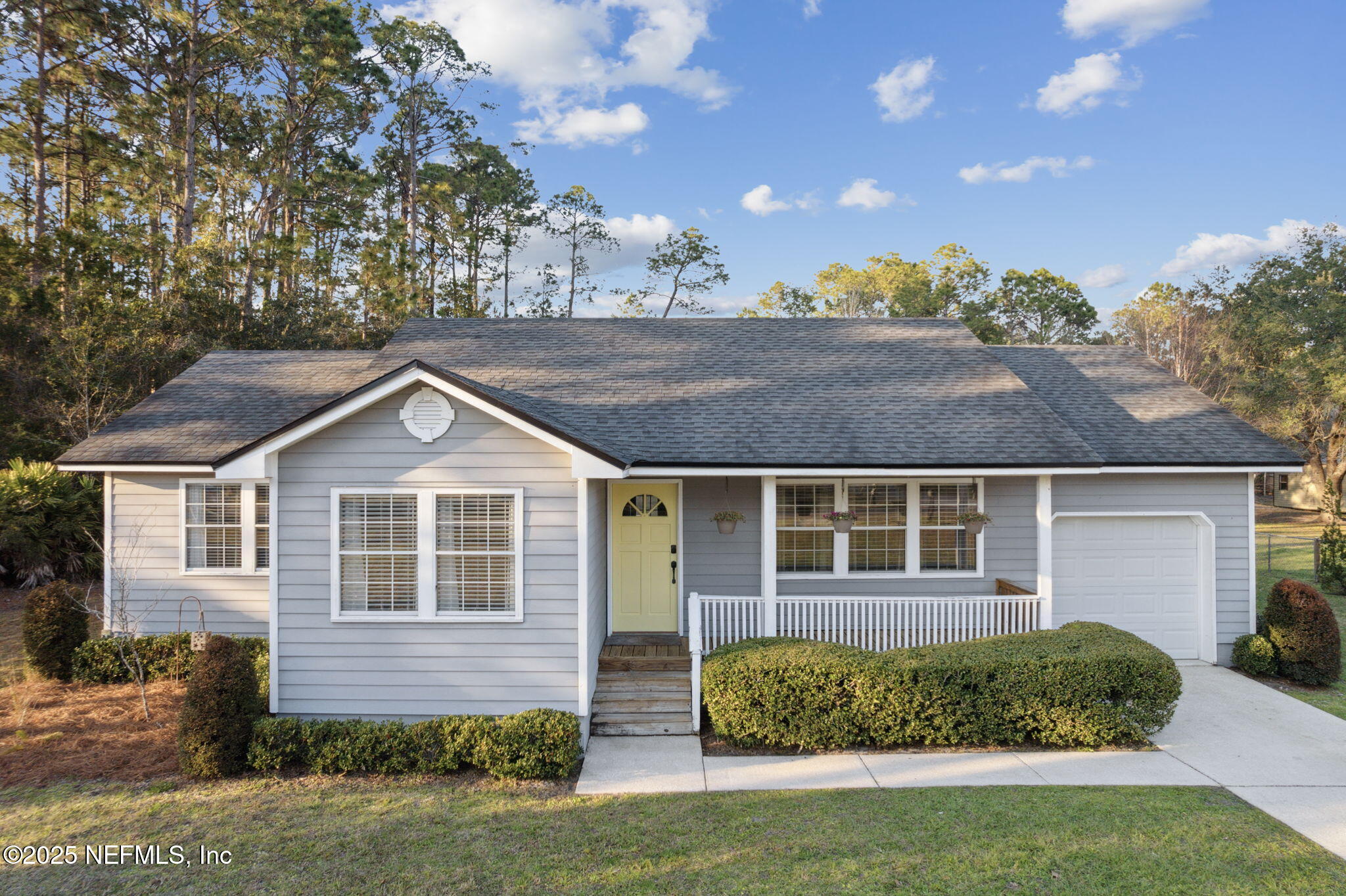86221 Spring Meadow Avenue Yulee, FL 32097 - Photo 2 of 23 a front view of a house with a garden
