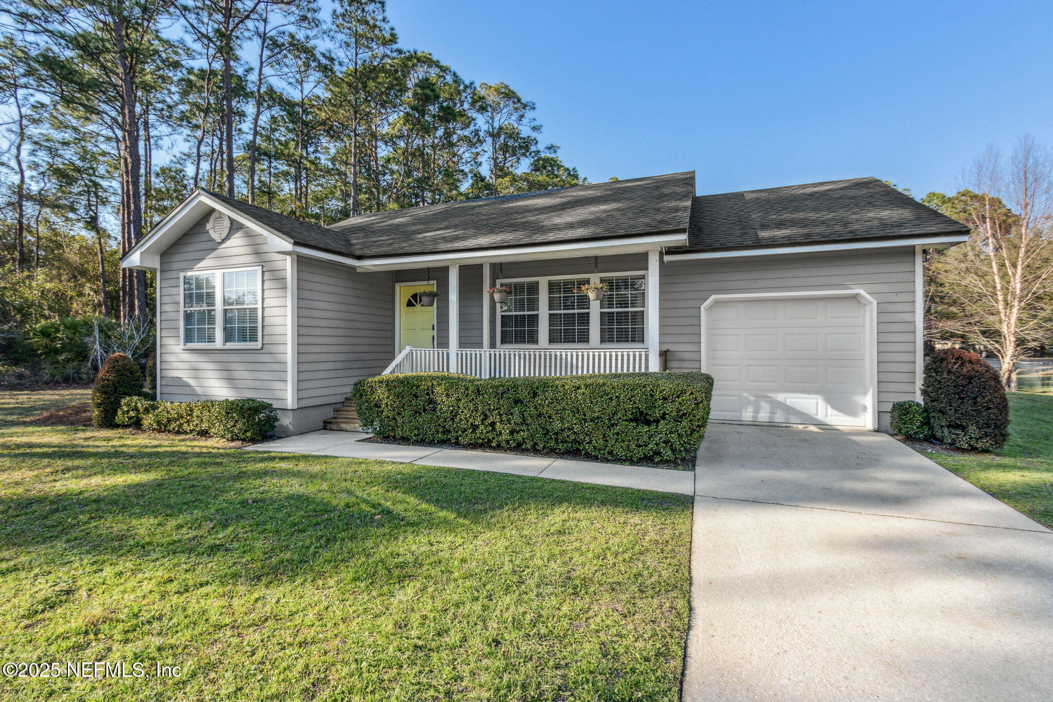 86221 Spring Meadow Avenue Yulee, FL 32097 - Photo 3 of 23 a front view of a house with a yard