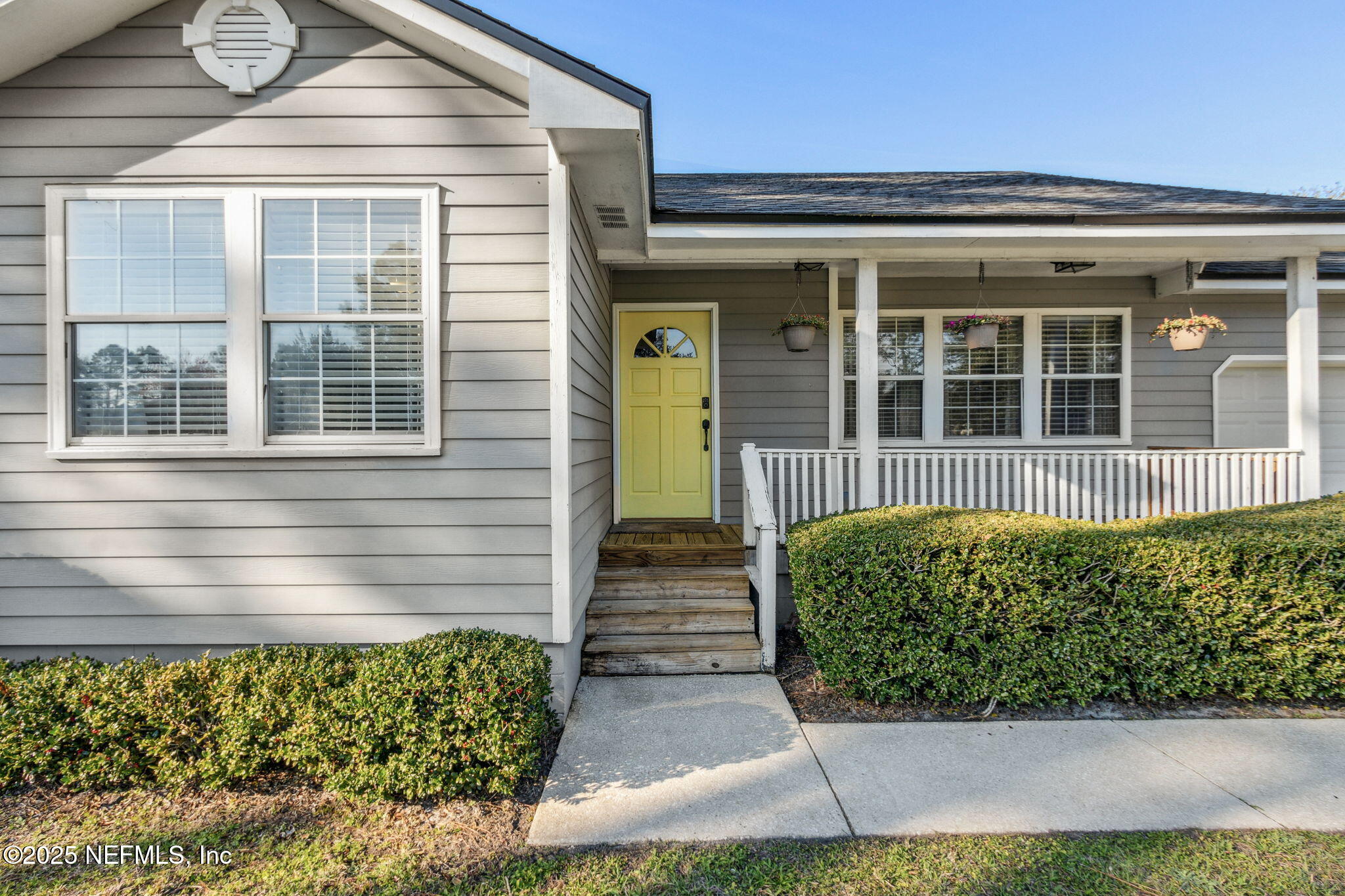 86221 Spring Meadow Avenue Yulee, FL 32097 - Photo 5 of 23 a front view of a house with garden