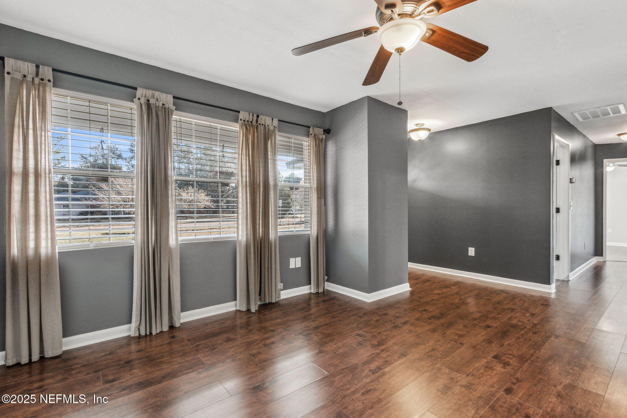 86221 Spring Meadow Avenue Yulee, FL 32097 - Photo 7 of 23 a view of an empty room with window and wooden floor